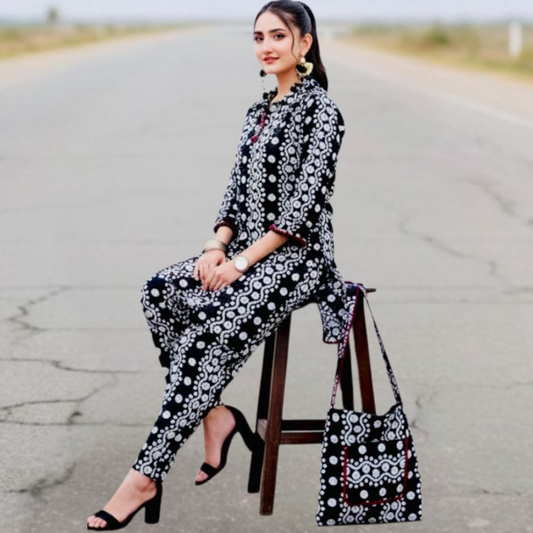 Elegant black and white Swiss printed outfit by SEIN ATTIRE, featuring a stylish shirt, matching trousers, and coordinated handbag.
