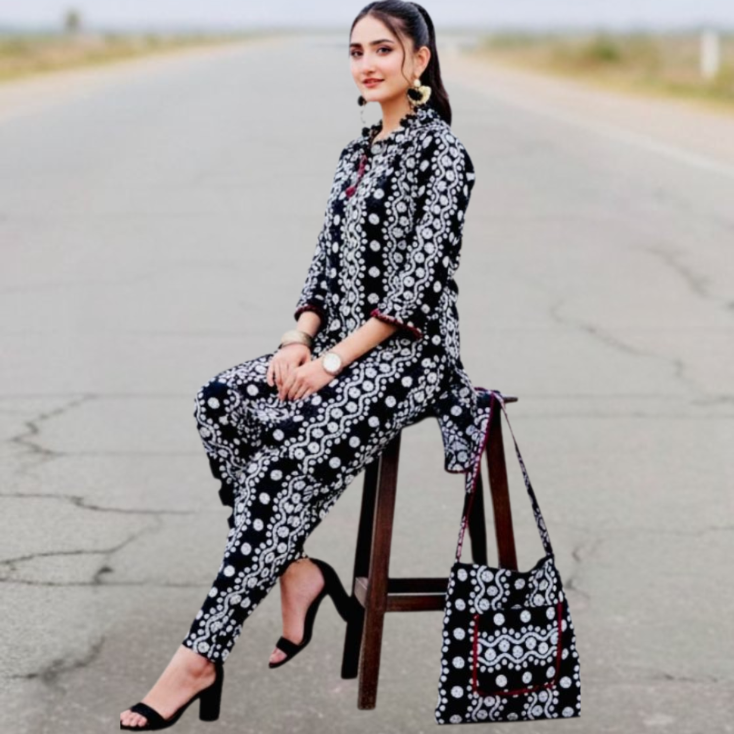 Elegant black and white Swiss printed outfit by SEIN ATTIRE, featuring a stylish shirt, matching trousers, and coordinated handbag.