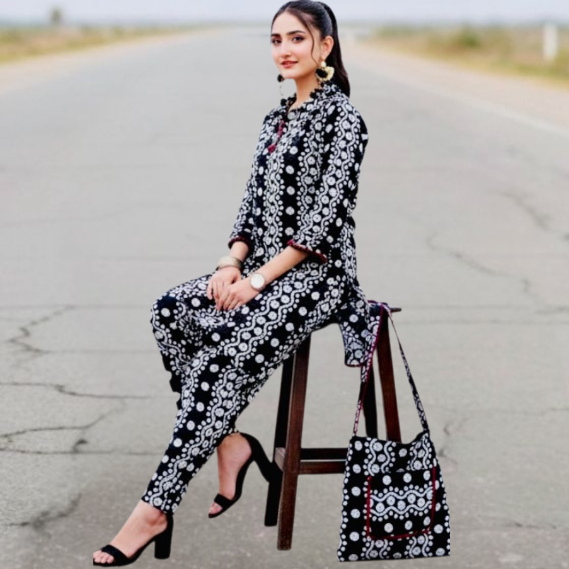 Elegant black and white Swiss printed outfit by SEIN ATTIRE, featuring a stylish shirt, matching trousers, and coordinated handbag.