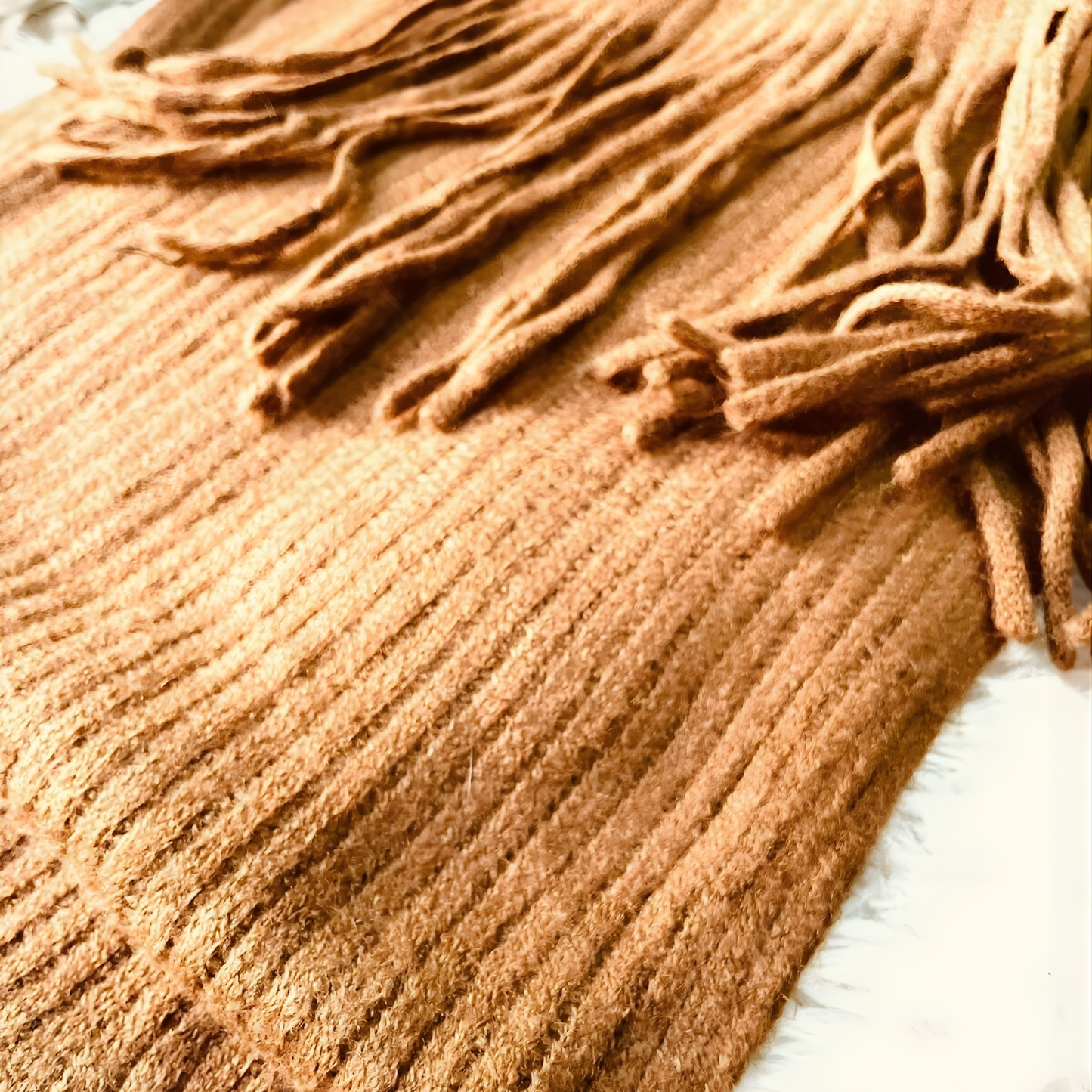 Cozy brown fashion scarf laid flat with elegant drape and tassels