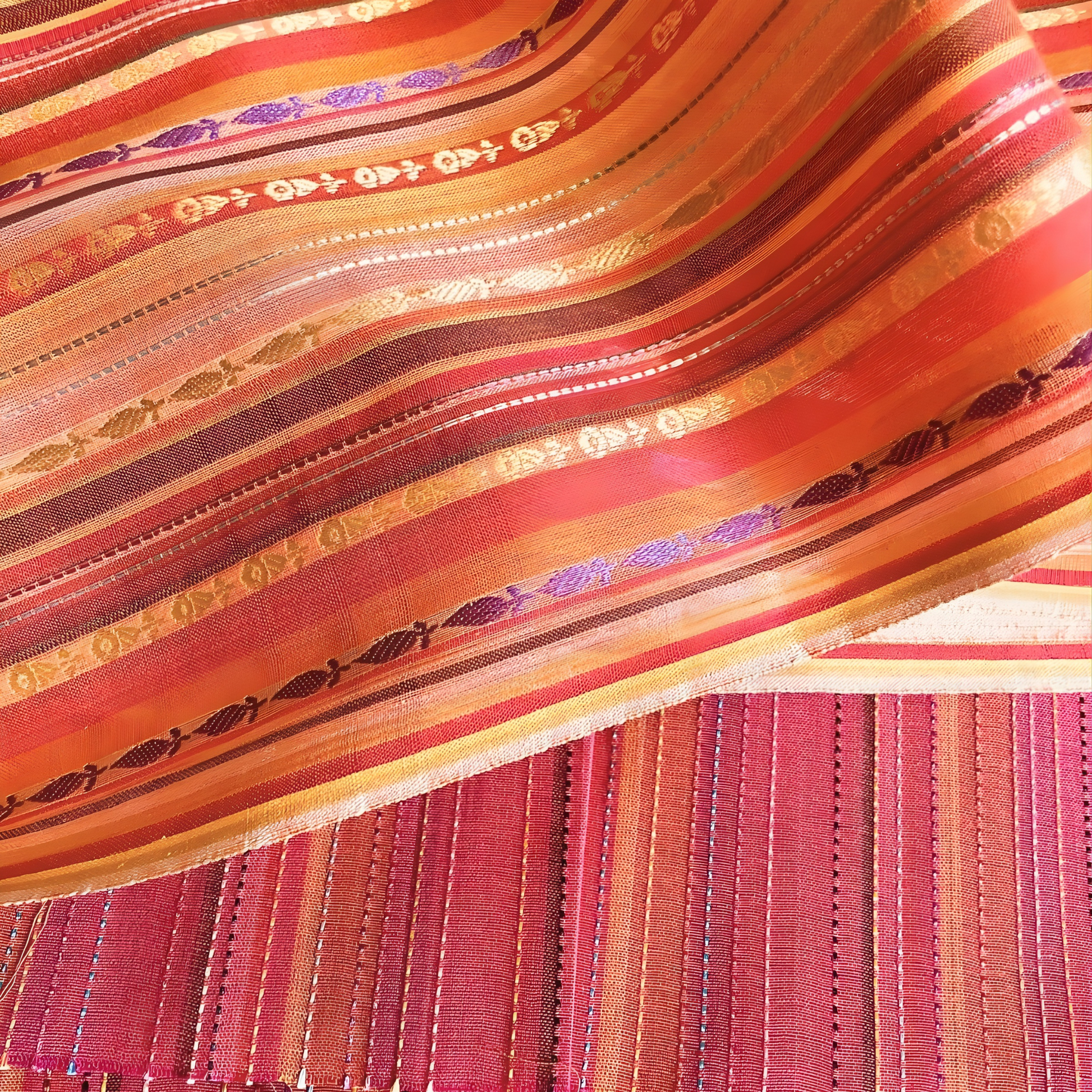Close-up view of jacquard motifs and multicolor striped pattern on red winter cotton fabric.