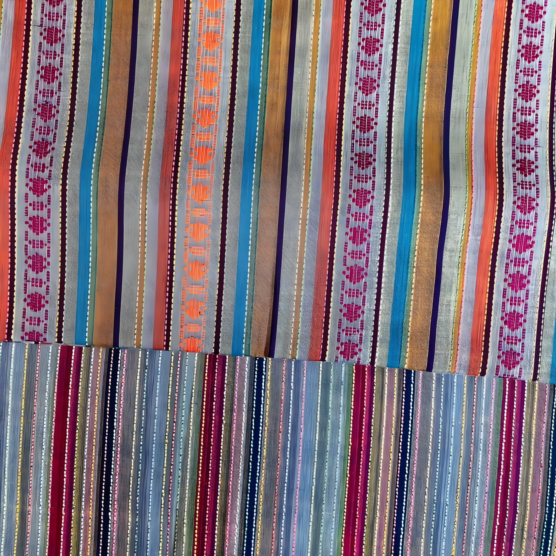 Close-up view of jacquard motifs and vibrant striped pattern on winter cotton fabric.